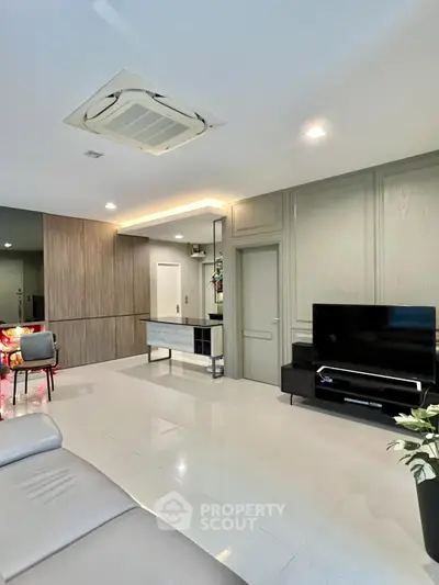 Modern living room with sleek design and large TV setup