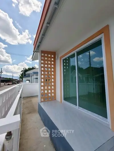 Charming exterior view of a modern home with spacious balcony and stylish design.