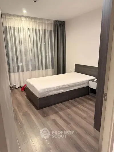 Modern bedroom with sleek flooring and minimalist design