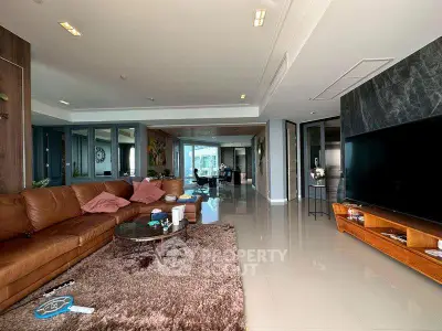 Luxurious open-plan living room with plush leather sofa and modern decor