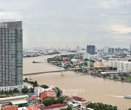 Stunning cityscape view with river and modern high-rise buildings.