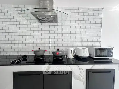 Modern kitchen with sleek appliances and stylish backsplash