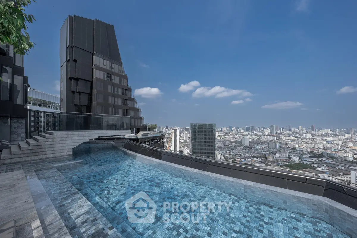 Stunning rooftop pool with panoramic city views in a modern high-rise building.