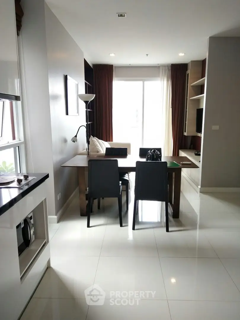 Modern living room with sleek furniture and natural light in a stylish apartment.