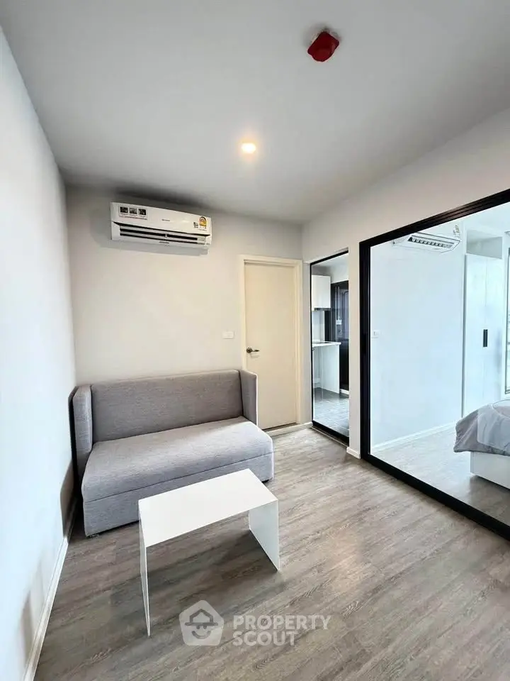 Modern living room with sleek design and air conditioning in a stylish apartment.