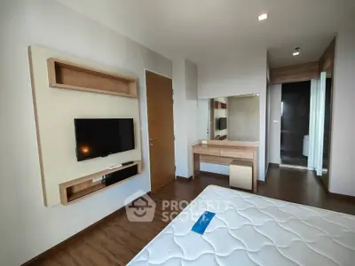 Modern bedroom with sleek design, featuring a wall-mounted TV and stylish wooden accents.