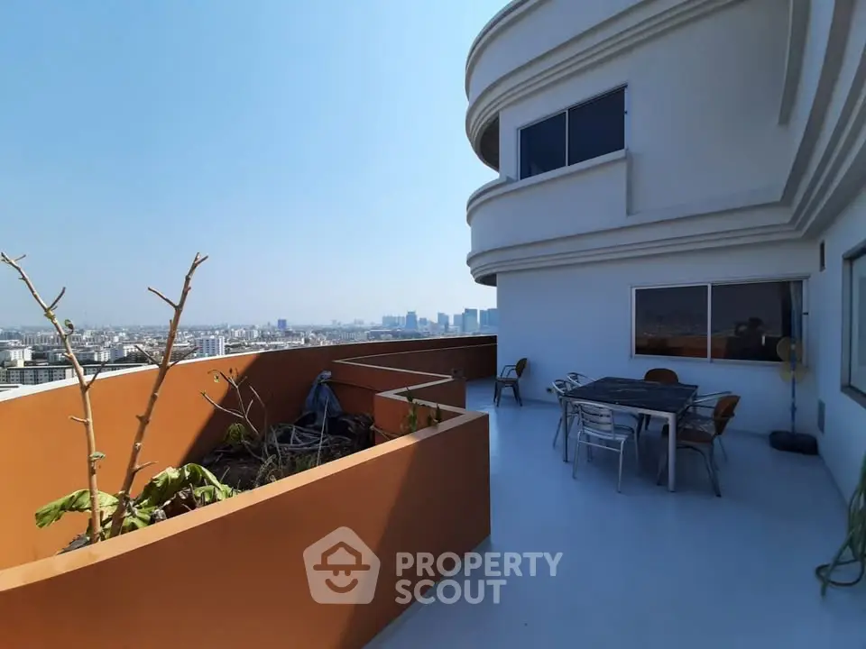 Stunning rooftop terrace with panoramic city views and outdoor dining area.