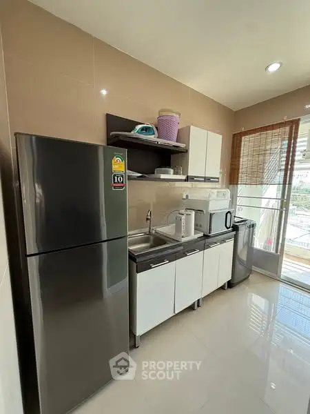 Modern kitchen with stainless steel fridge and appliances in bright apartment