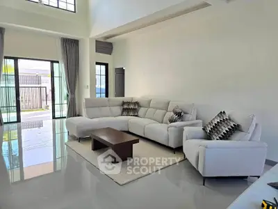 Spacious modern living room with elegant sofa and natural light