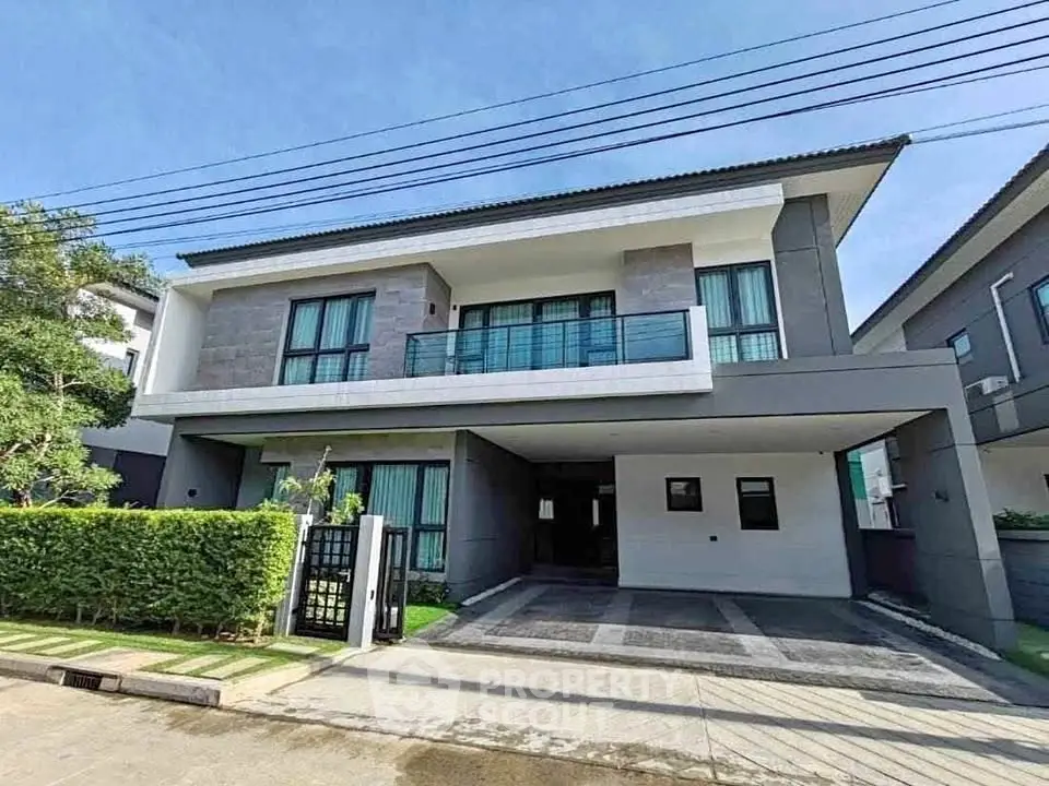 Modern two-story house with spacious driveway and lush greenery.