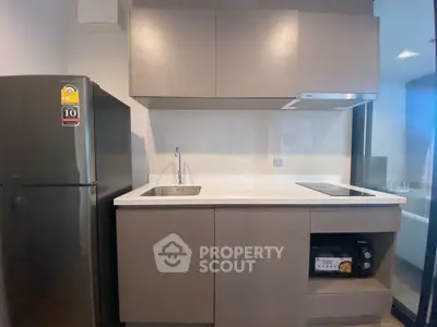 Modern kitchen with sleek cabinetry and built-in appliances in a contemporary apartment.