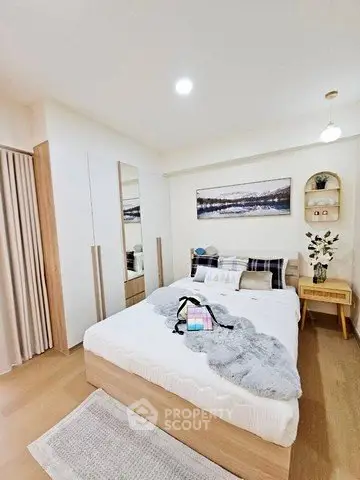 Cozy modern bedroom with stylish decor and ample natural light