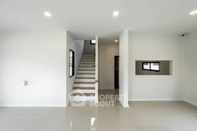 Modern minimalist interior with staircase and bright lighting