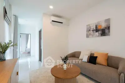 Modern living room with stylish decor and air conditioning in a cozy apartment.