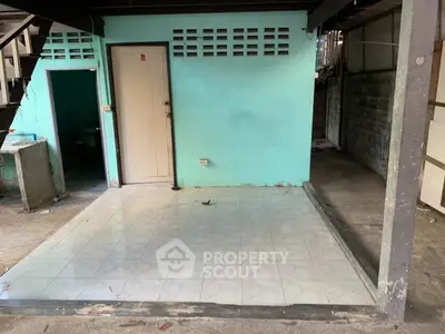 Basic unfinished interior space with tiled floor and turquoise walls