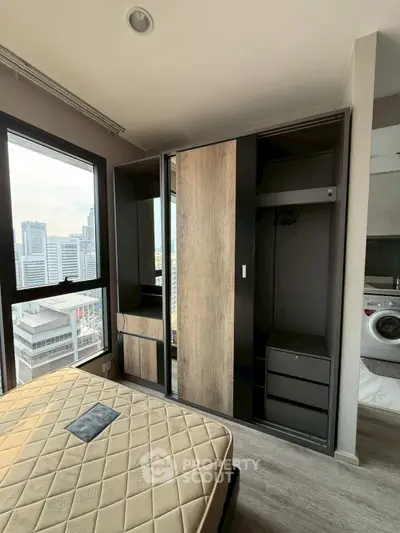 Modern bedroom with city view and built-in wardrobe