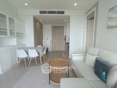 Modern living room with white furniture and dining area in open layout