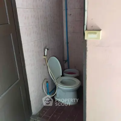 Compact bathroom with toilet and bidet in a small space