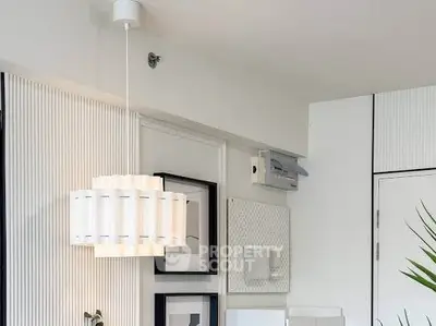Modern interior with stylish lighting and wall decor in a contemporary apartment.