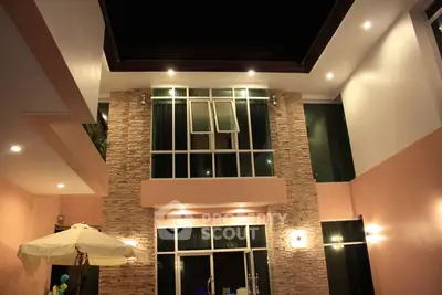 Stunning modern home exterior with elegant lighting and stone accents