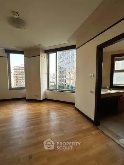 Spacious corner unit with large windows offering city views and abundant natural light.