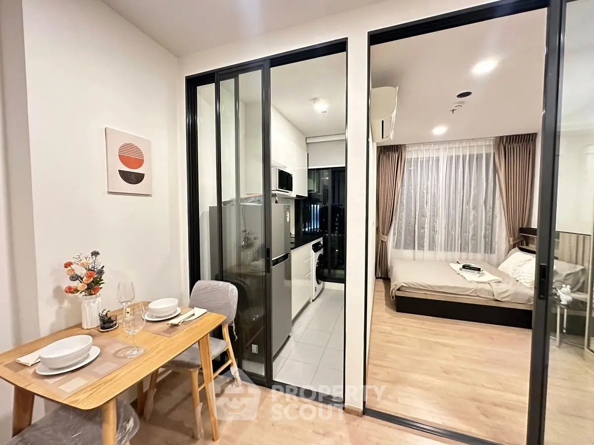 Modern apartment with open kitchen and cozy bedroom, ideal for urban living.
