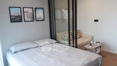Modern bedroom with stylish decor and cozy seating area, perfect for urban living.