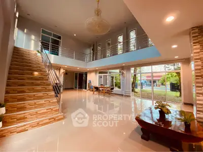 Spacious modern living area with elegant staircase and large windows