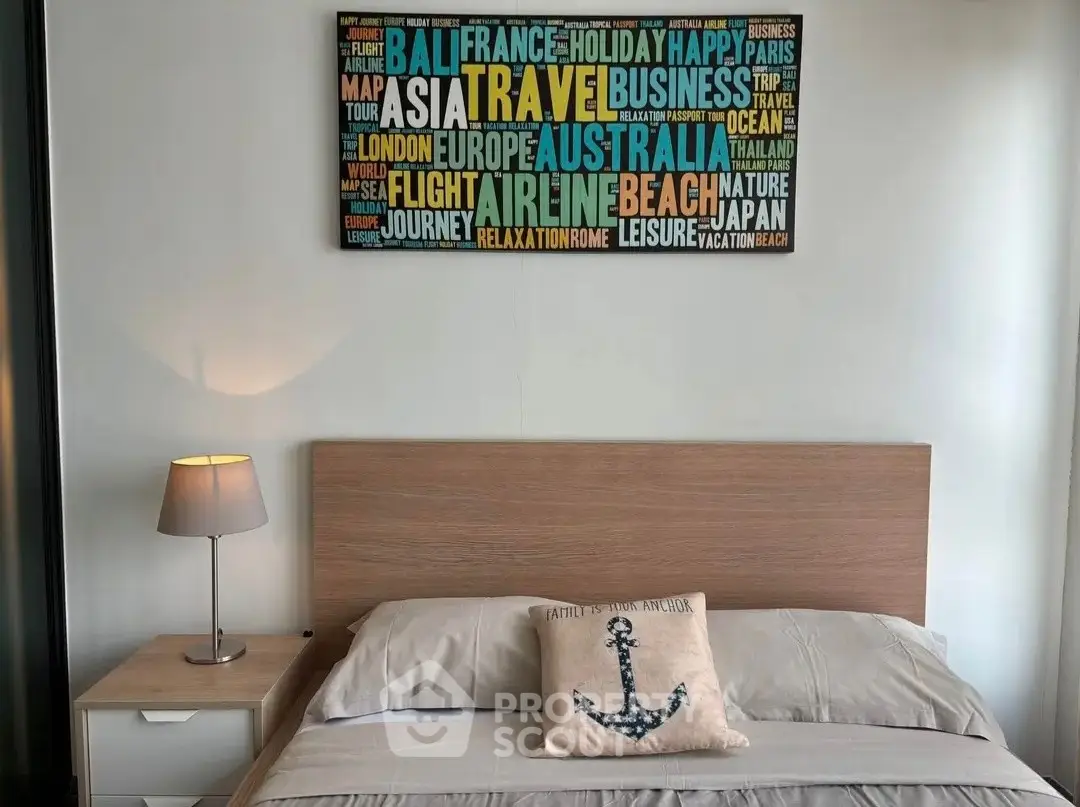 Cozy bedroom with modern decor and travel-themed wall art, perfect for relaxation.