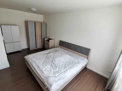 Spacious bedroom with modern furniture and natural light