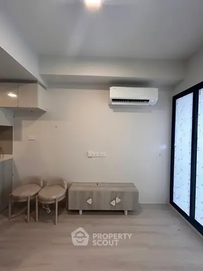 Modern minimalist living room with air conditioning and sleek furniture