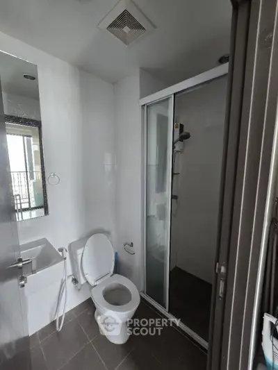 Modern bathroom with shower and toilet in sleek apartment