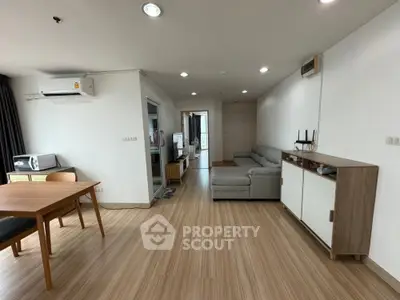 Spacious modern living room with wooden flooring and stylish furniture