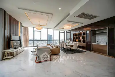 Luxurious open-plan living room with marble floors and city view, featuring elegant chandeliers and modern furnishings.