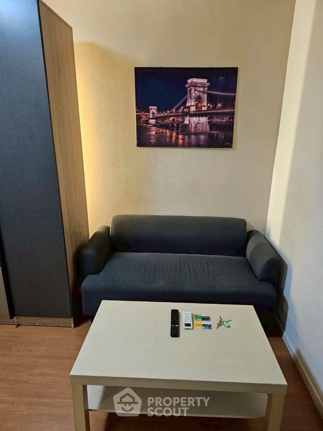 Cozy living room with modern sofa and stylish wall art, perfect for relaxation.
