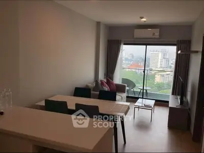 Spacious living room with modern furnishings, ample natural light, and a serene cityscape view through large windows, perfect for urban living.