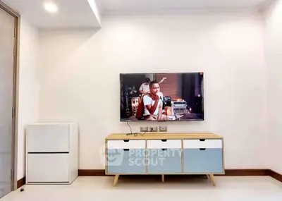 Modern living room with sleek TV setup and stylish storage unit