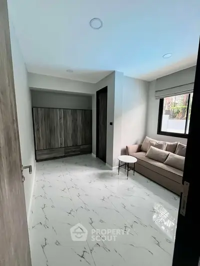 Modern minimalist living room with marble flooring and cozy sofa
