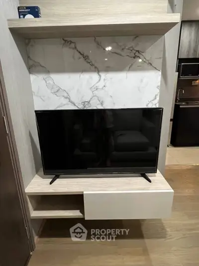 Modern living room with sleek TV unit and marble accent wall