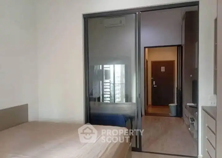 Modern bedroom with sliding glass door and minimalistic design