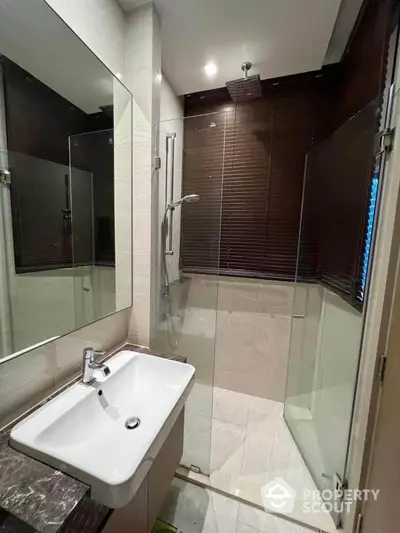 Modern bathroom with glass shower and sleek sink design