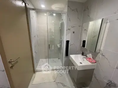 Modern bathroom with sleek shower and elegant marble tiles