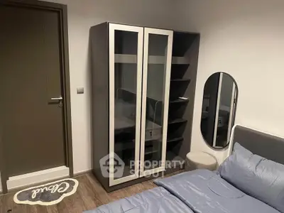 Modern bedroom with sleek wardrobe and cozy bedding, perfect for stylish living.