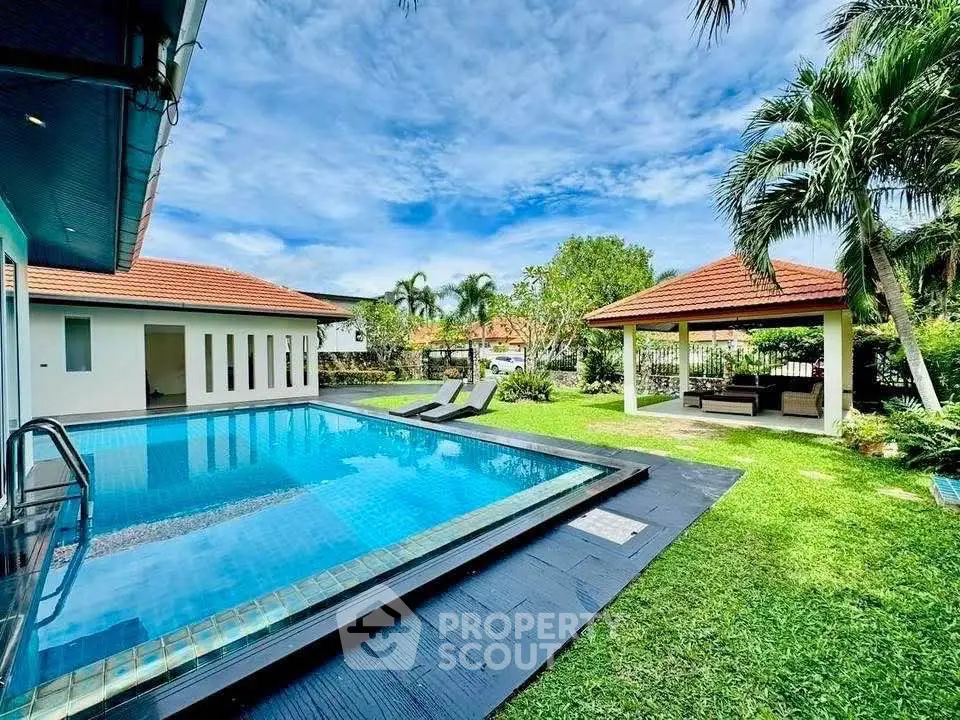 Luxurious villa with private pool and lush garden, perfect for tropical living.