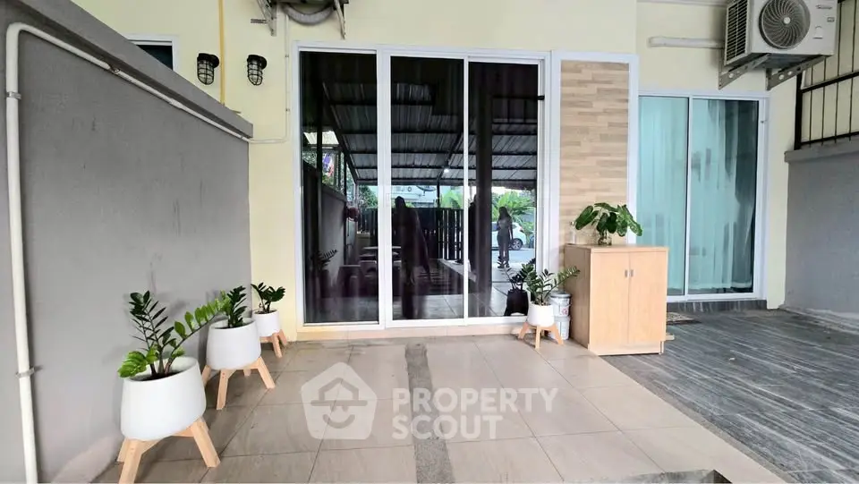Charming patio entrance with sliding glass doors and modern decor