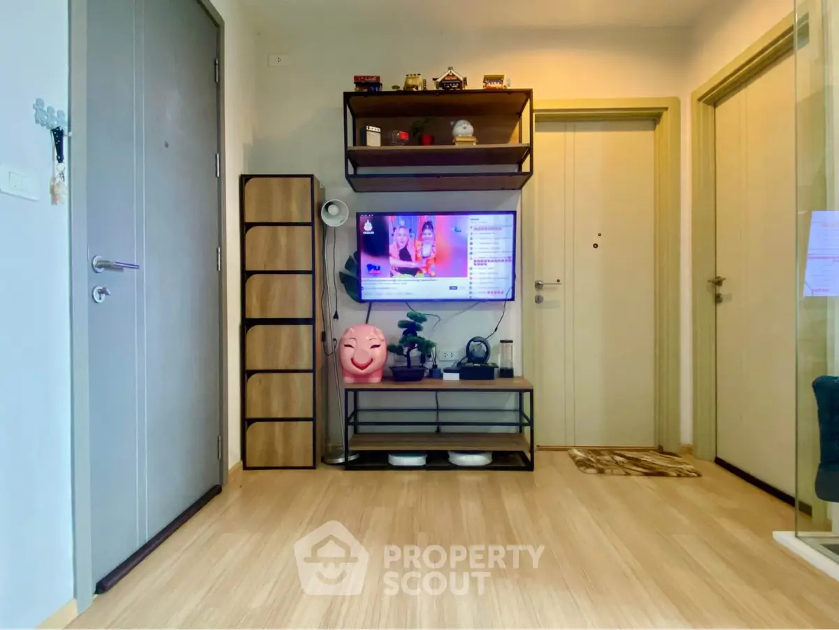 Modern living room with stylish wooden flooring and sleek TV setup.
