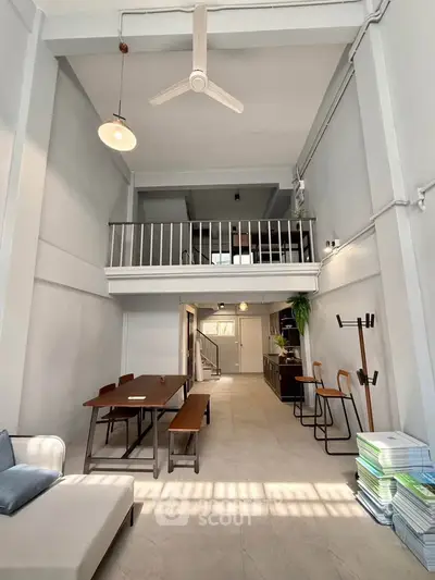 Spacious loft-style living room with high ceilings and modern decor
