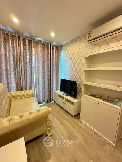 Charming living room with elegant sofa, TV, and stylish curtains in a cozy apartment.