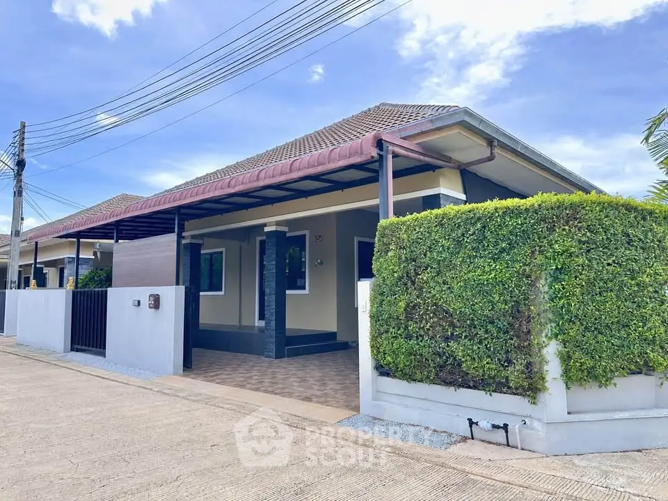 Charming single-story home with lush greenery and modern exterior design, perfect for family living.