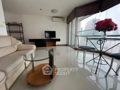 Modern living room with city view, featuring sleek furniture and large windows for natural light.